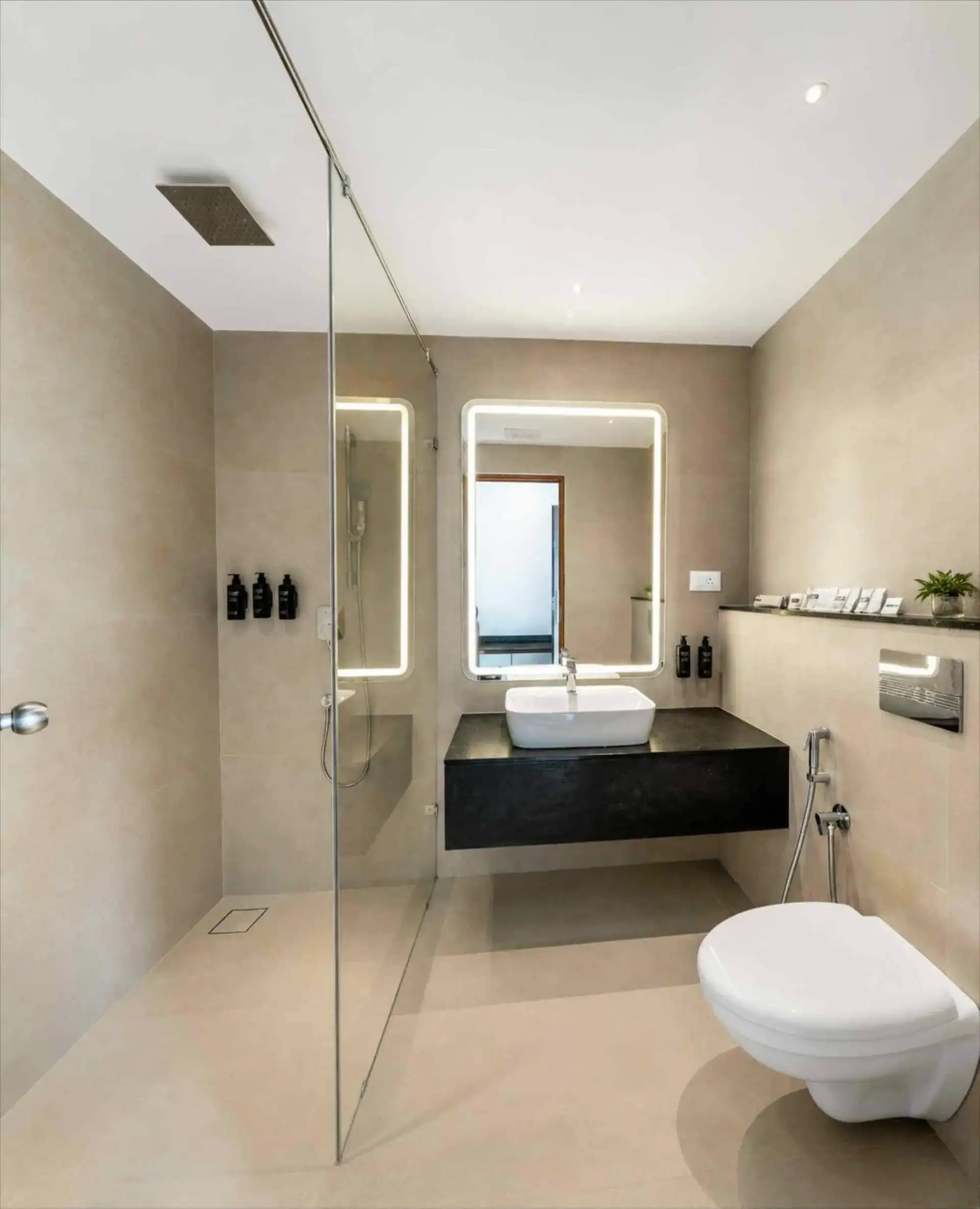 Rain shower head and floating dark-wood vanity in the en-suite bathroom