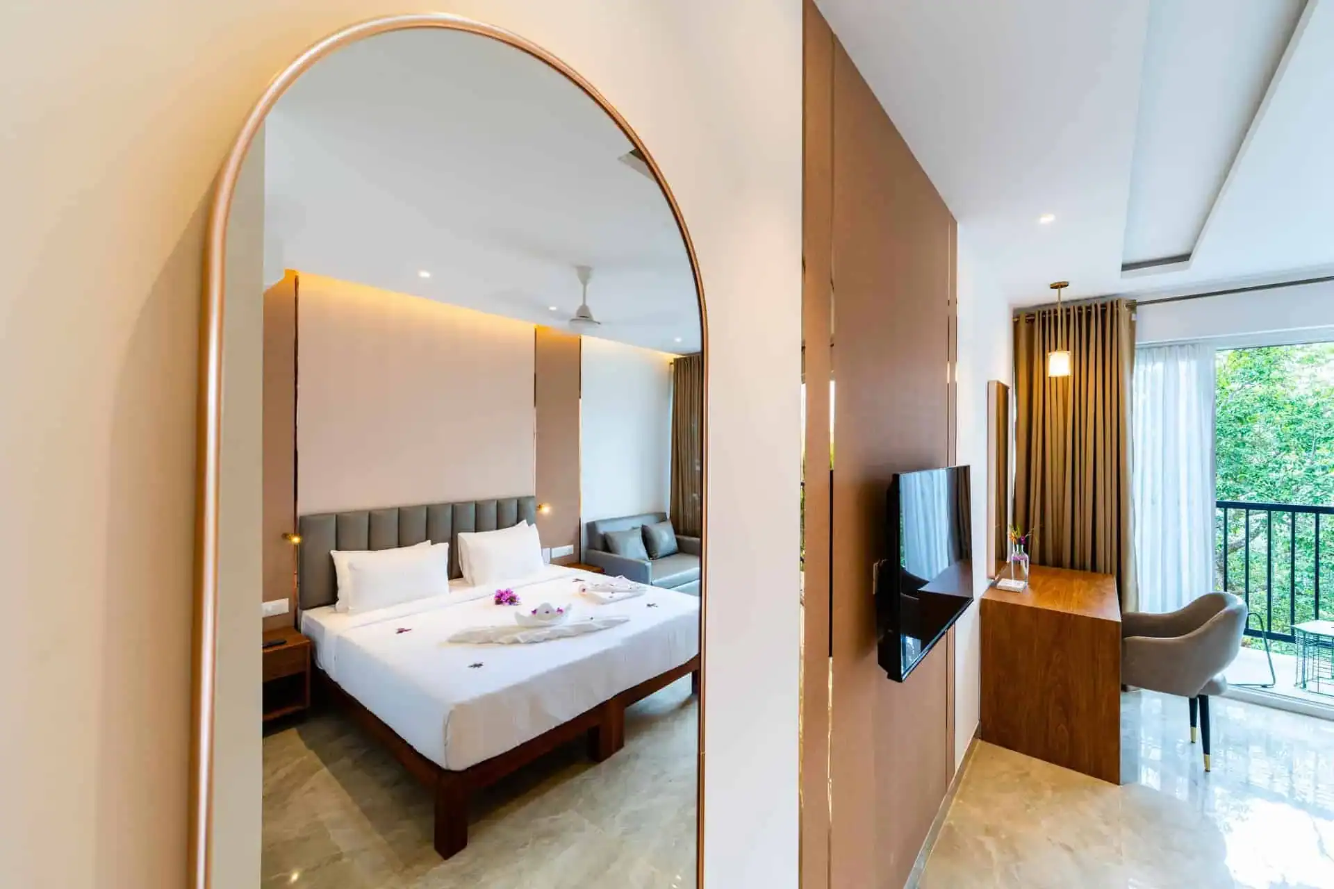 Artistic composition using arched gold mirror reflecting the Vega Bliss Cottage interior