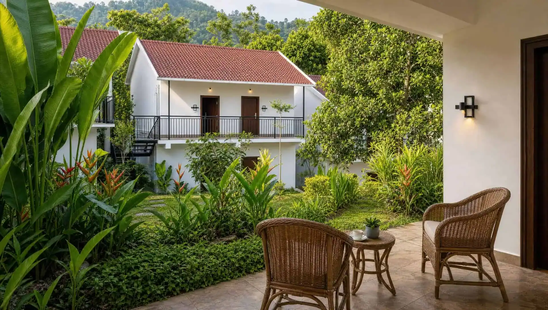 Vega Delight Cottage private garden patio with tropical plants and rattan seating
